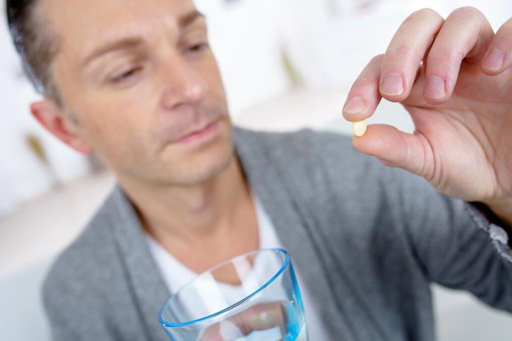 a man drinks a pill to increase potency